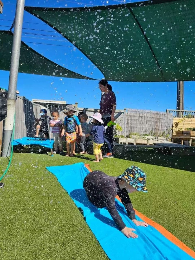 Tamariki playing outdoors under shade sails