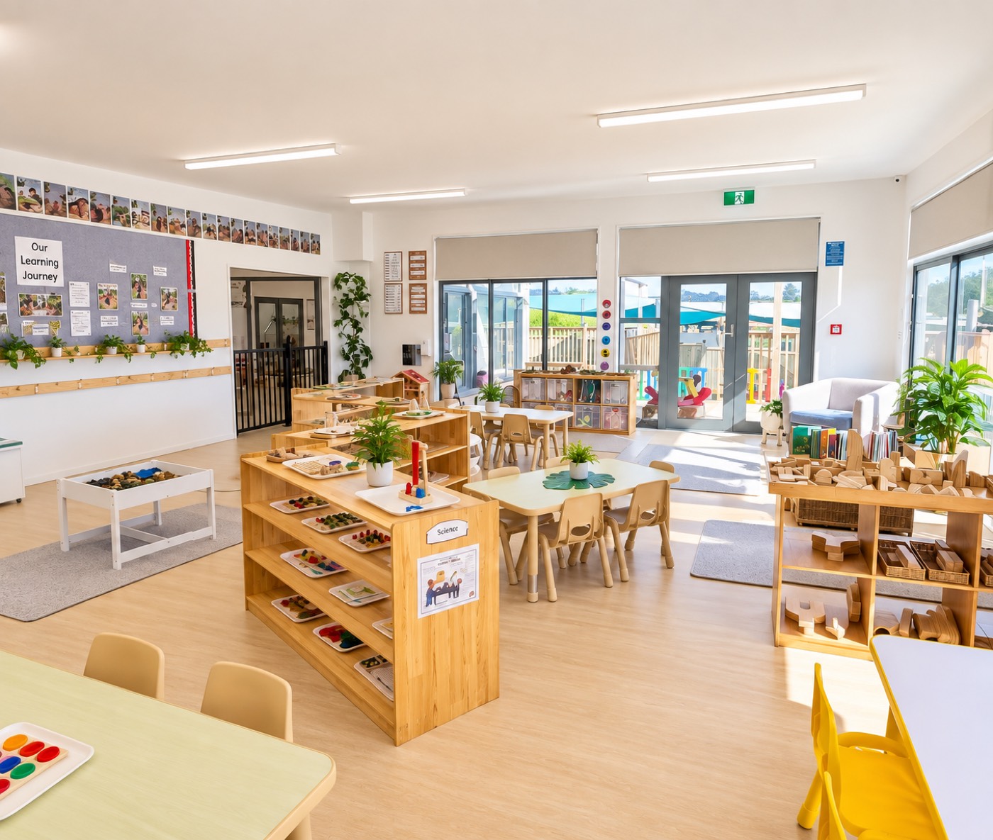 A bright, open learning room with wooden shelves and tables