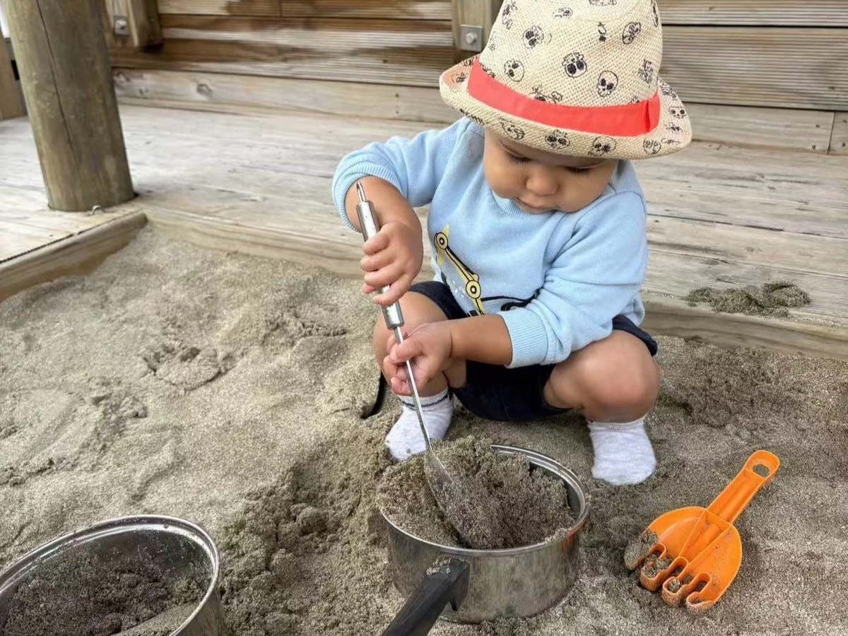 A baby digging in the sandpit
